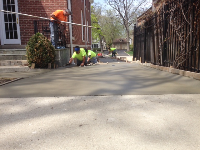 Atlanta concrete repair team installing a new driveway between houses