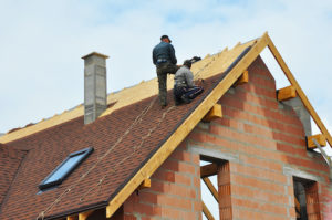 two roofers working on roof installation