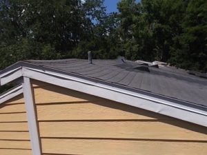 sagging roof with displaced shingles