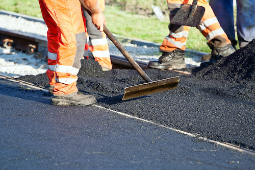 workers laying asphalt