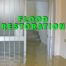 Flood restoration written in green over basement with standing water
