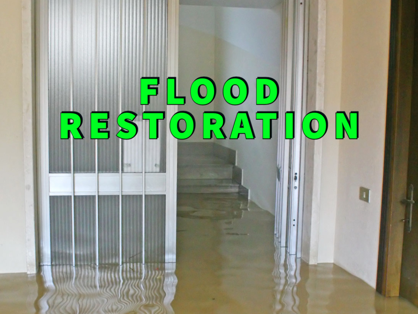 Flood restoration written in green over basement with standing water