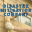 disaster mitigation company written in blue over worker nailing plywood to window