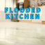 flooded kitchen written in blue over water on kitchen floor