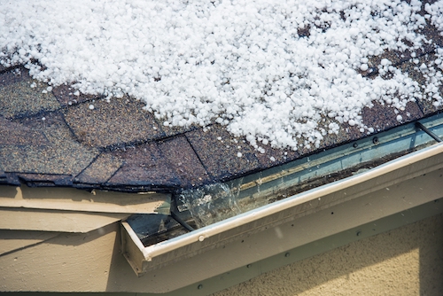 Small Melting Hail on the Roof with water flowing into gutter