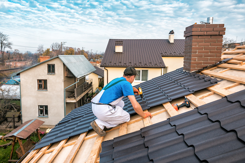 professional roofer installing metal shingles