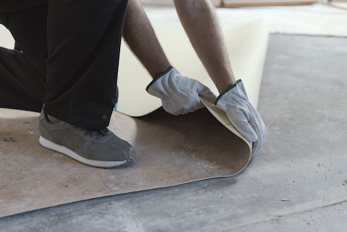 Professional contractor removing an old linoleum flooring