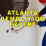 Atlanta demolition expert written in yellow over man in blue jumpsuit demolishing drywall with sledgehammer