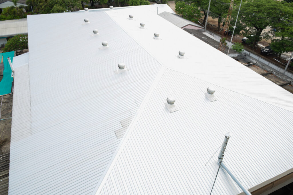 Aerial view of metal commercial roof with two rows or air vents