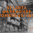 Atlanta warehouse construction written in orange over black and white image of stocked warehouse