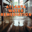 Atlanta water remediation written in orange over water seeping atop hardwood floor