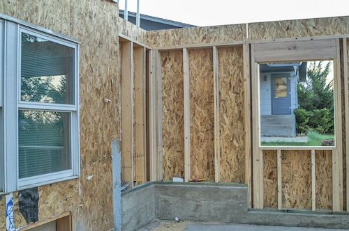 Wooden inside walls without a roof and two windows