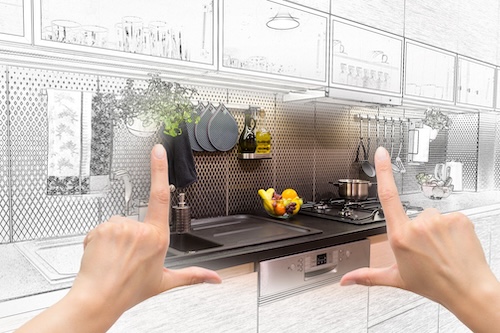 Female hands framing custom kitchen design. Combination drawing and photo.