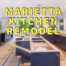 Marietta kitchen remodel written in yellow over gutted kitchen with wooden framed island and cabinets