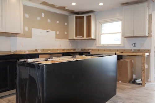 Kitchen under renovatioin with new cabinets, counter and a center islnad being constructed.