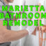 marietta bathroom remodel written in green ocer man installing tile next to copper shower fixture